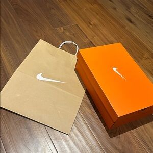 Two Nike shoe boxes and 7 various size paper bags.
